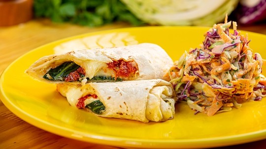 Wrap de Queijo, Tomate Seco e Rúcula com Salada de Repolho, refeição completa.